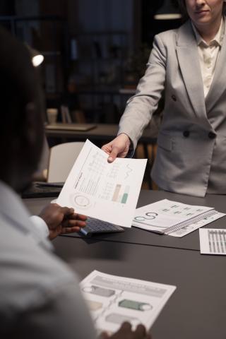 ISO 27001-woman-giving-report-her-boss